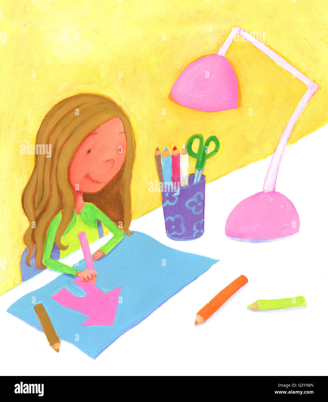 Girl sitting at her desk drawing with pencils a pink house Stock Photo