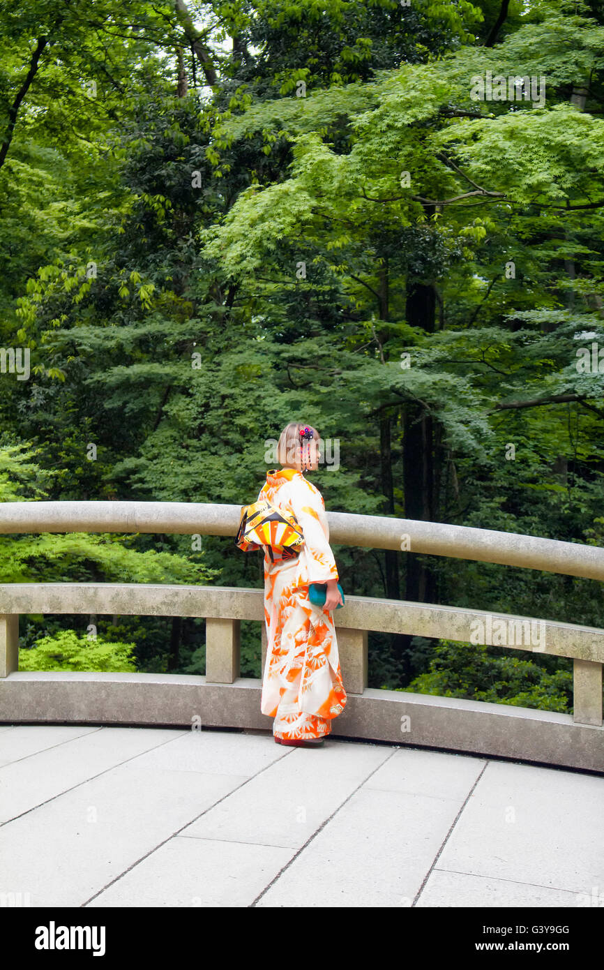 TOKYO - MAY, 2016: Young female wearing traditional Japanese outfit pose at Meiji Shrine at Yoyogi park on May 28, 2016 Stock Photo