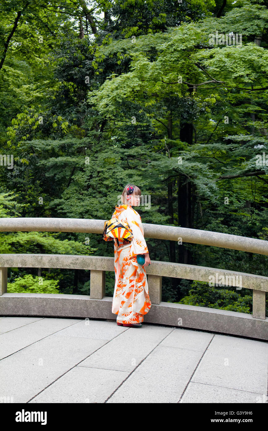 TOKYO - MAY, 2016: Young female wearing traditional Japanese outfit pose at Meiji Shrine at Yoyogi park on May 28, 2016 Stock Photo