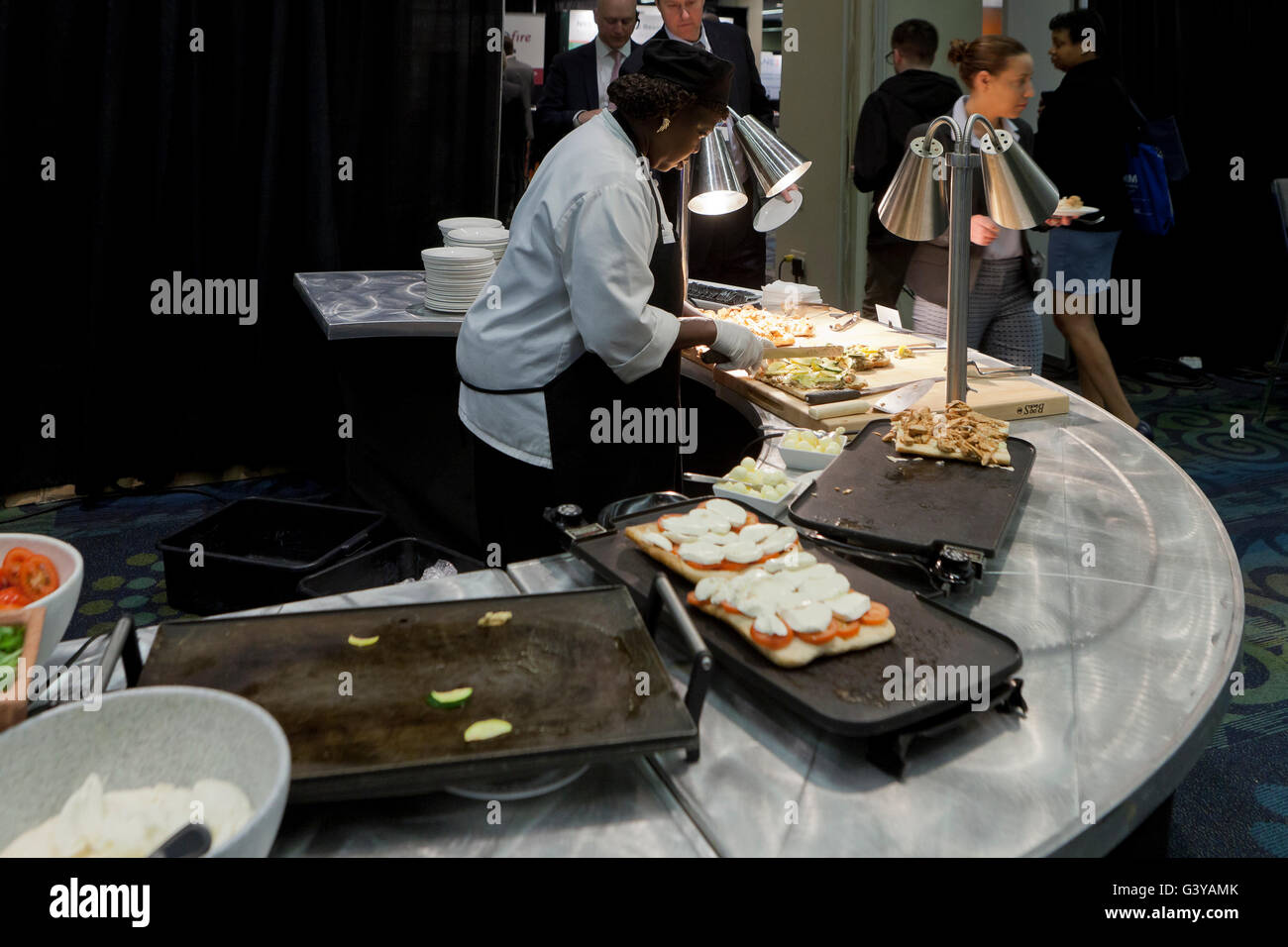 African-American female cook preparing grilled sandwiches - USA Stock Photo