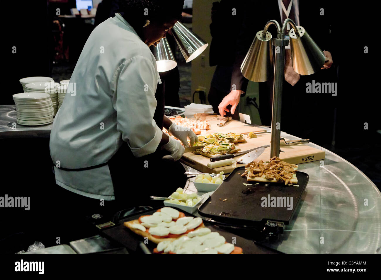 African-American female cook preparing grilled sandwiches - USA Stock Photo