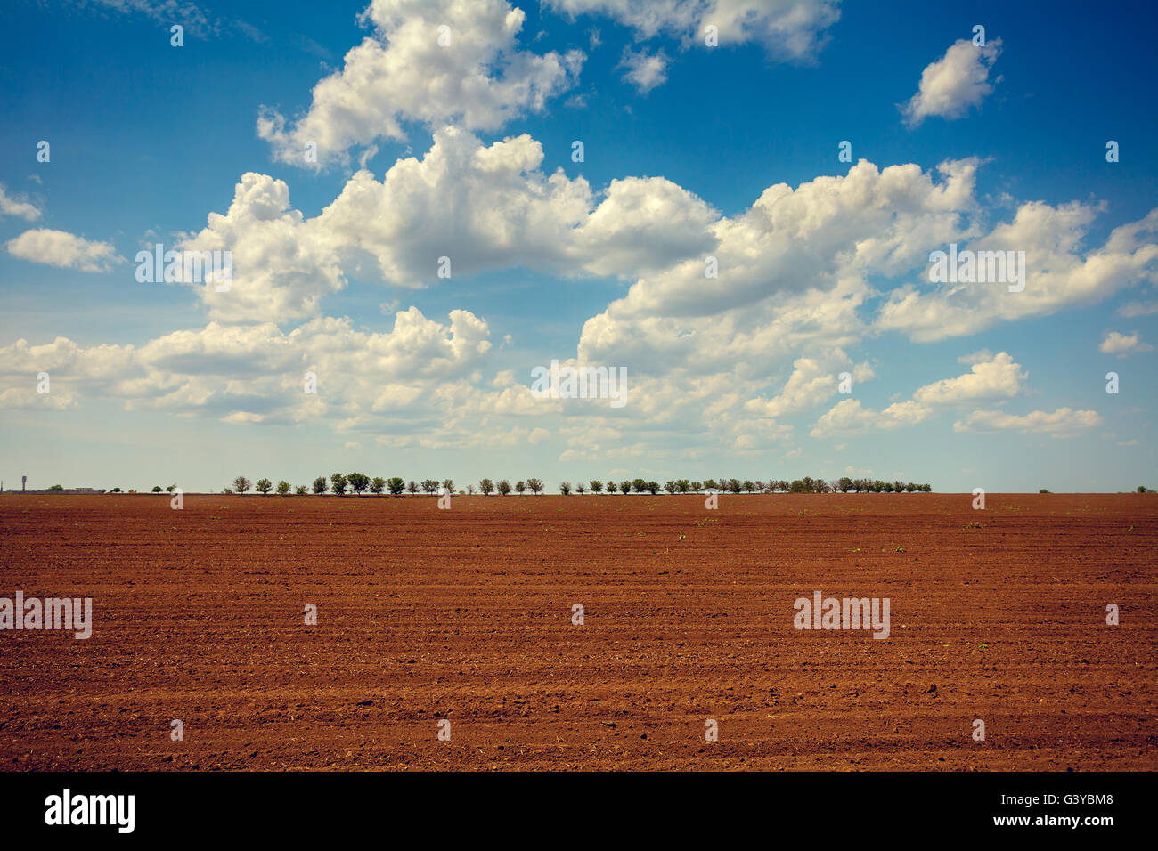 Cloudy blue sky under arable field Stock Photo - Alamy