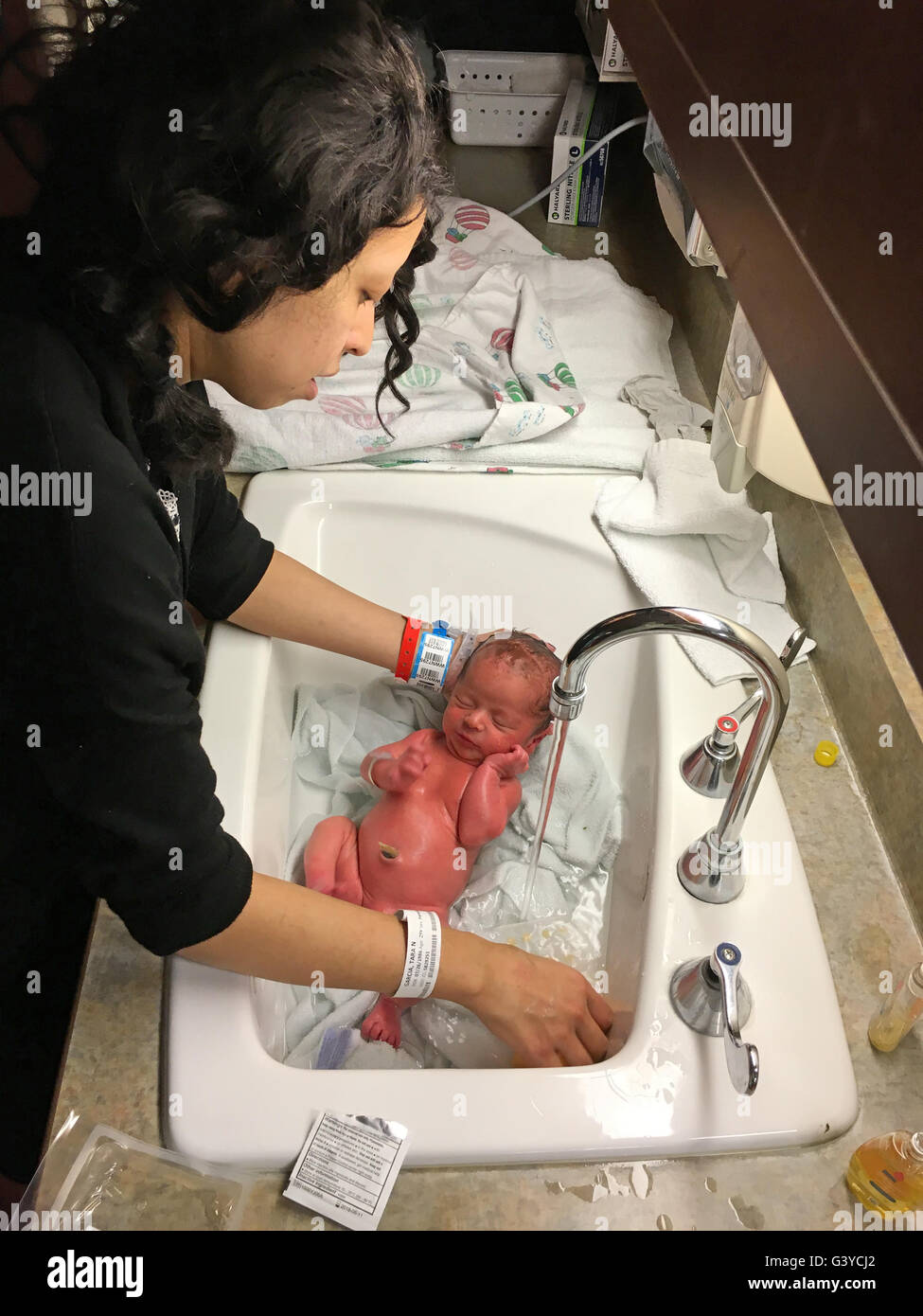 Mother Washing Her Baby In Sink In Natal Intensive Care Unti