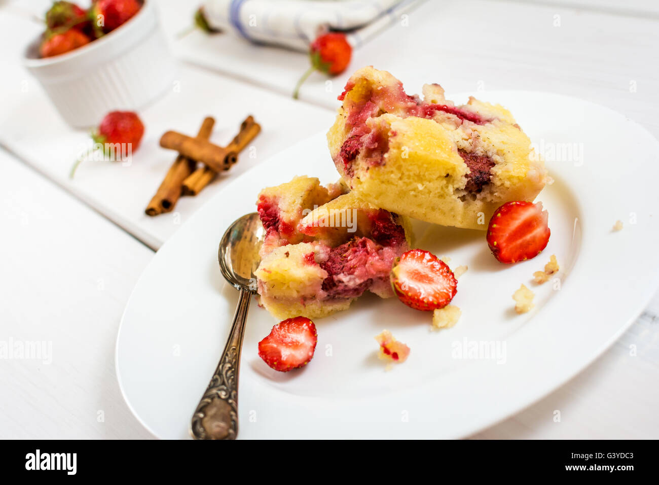 Tradittional czech dessert  pie with strawberries and glass of milk on white wood table Stock Photo