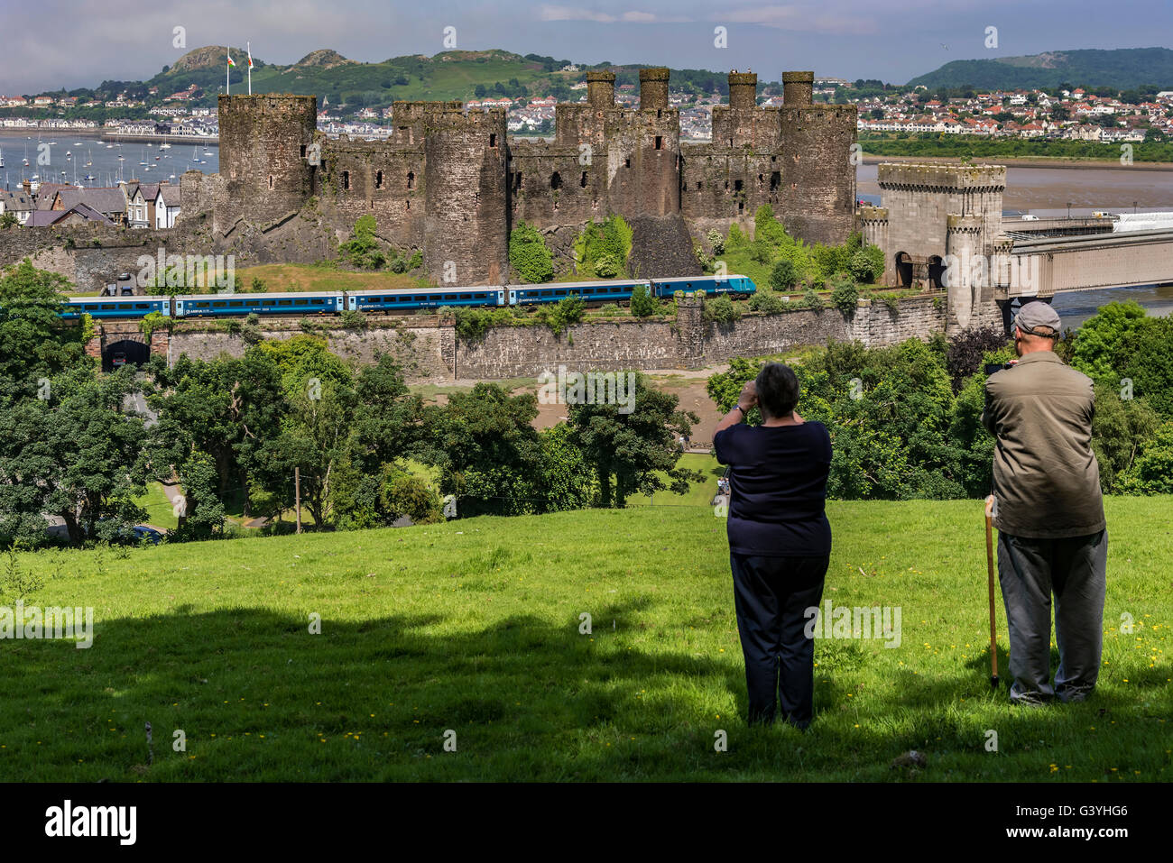Conwy Castle Gwynedd North Wales on the river Conwy. Conway Train spotters Arriva train. Stock Photo