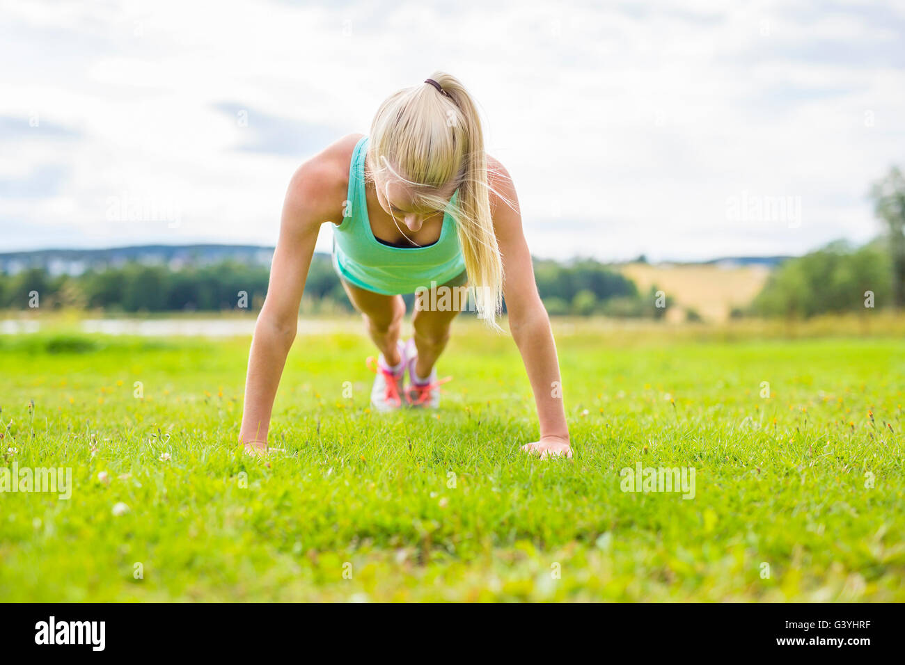 Young Woman Doing Push Ups In The Park Stock Photo Alamy