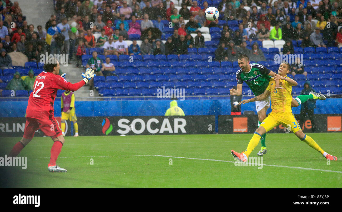 Northern Ireland's Gareth McAuley scoring his sides first goal of the match with team mates during the UEFA Euro 2016, Group C match at the Parc Olympique Lyonnais, Lyon. Stock Photo