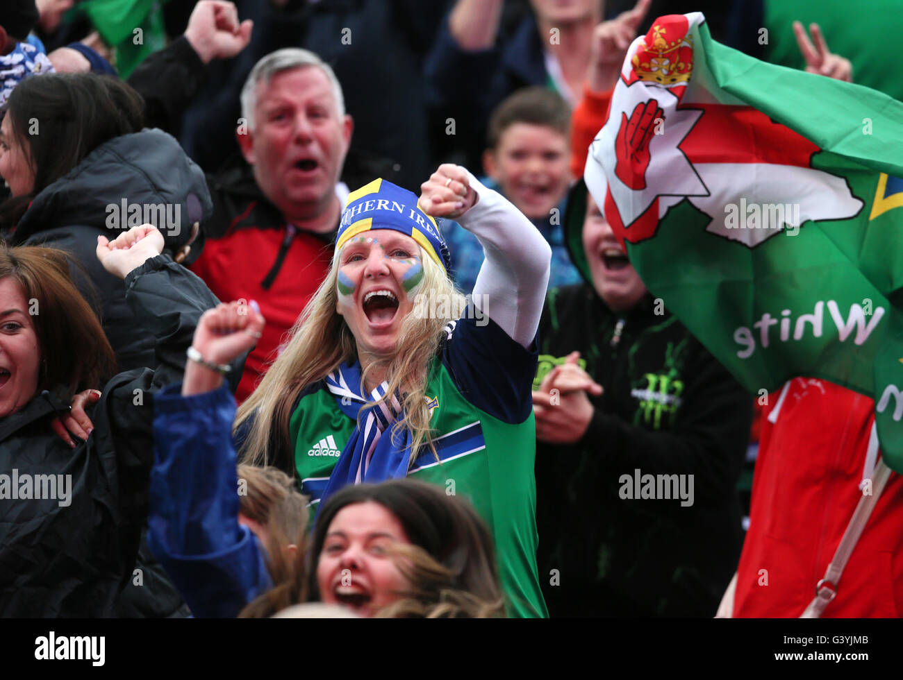 Northern Ireland fans celebrate at the final whistle in the official fan zone at The Titanic