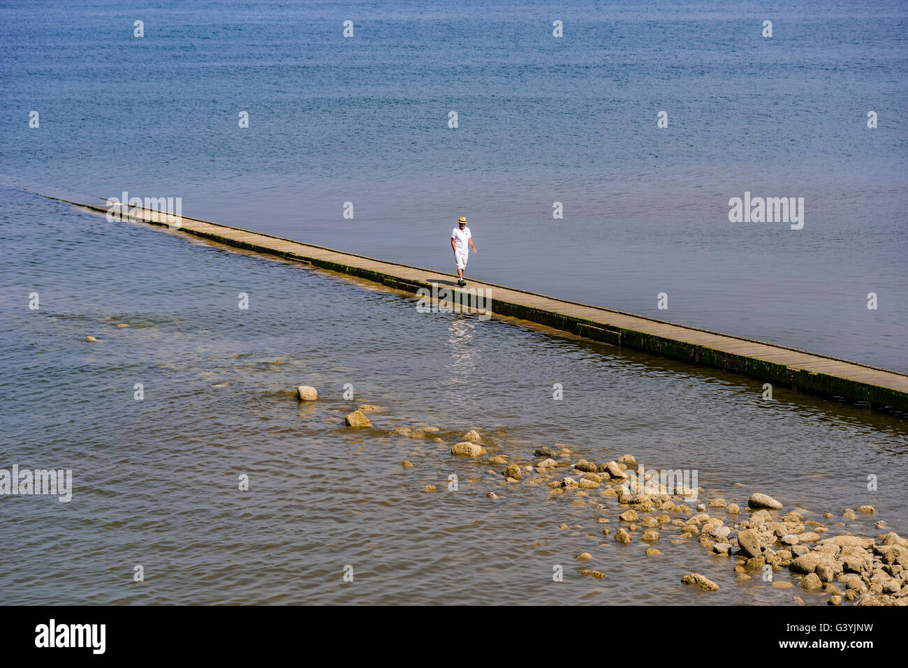 A solitary holidaymaker on a pier in Llandudno. Clwyd North Wales. Stock Photo