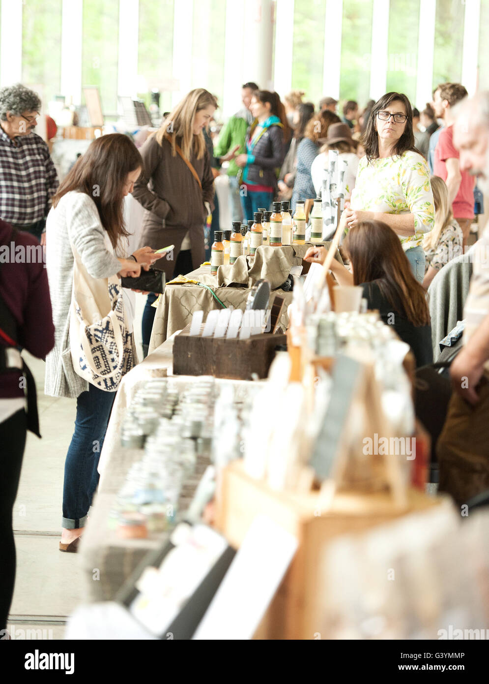 Crowds at the annual refresh market at the West Coast Railway Park.  Shopping at a trendy family craft market.  Squamish BC, Canada., Stock Photo