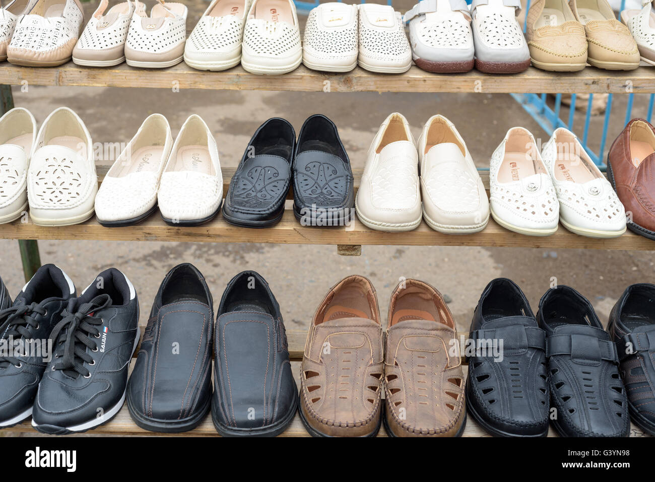 Rows of Shoes for Sale at a Market Stall Stock Photo