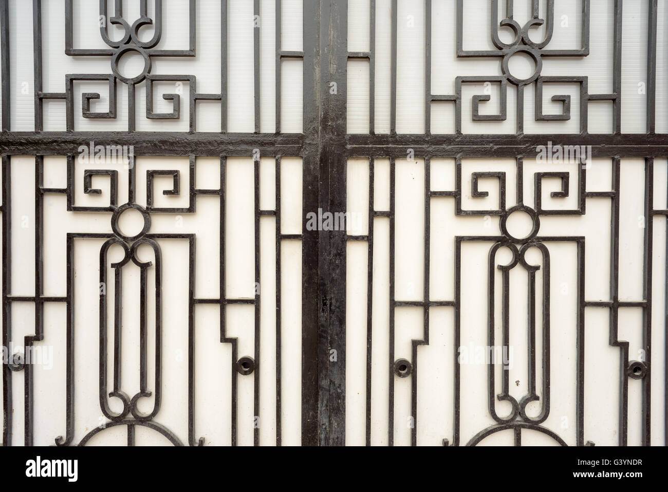Ornate cast iron metal window grill black on white Stock Photo