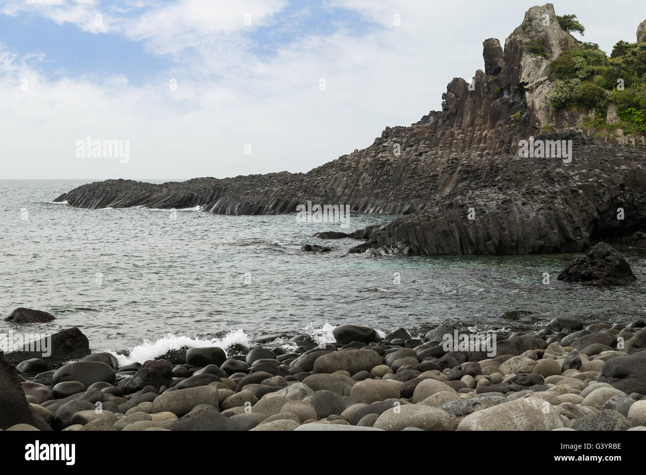 Rocky coastline near Daepo Jusangjeolli Cliff on Jeju Island in South Korea. Stock Photo