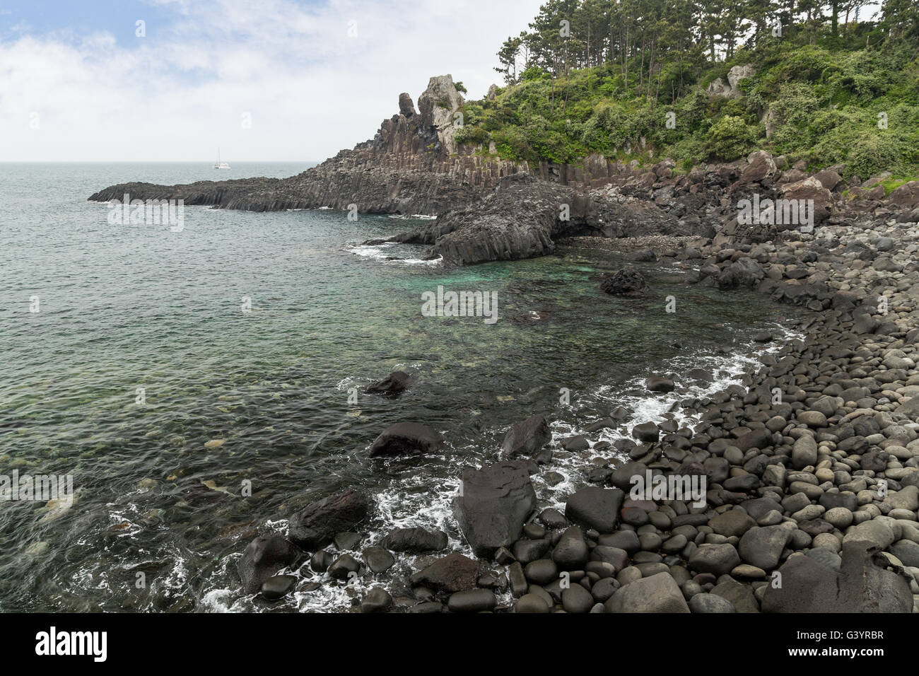 Rocky beach and coastline near Daepo Jusangjeolli Cliff on Jeju Island in South Korea. Stock Photo
