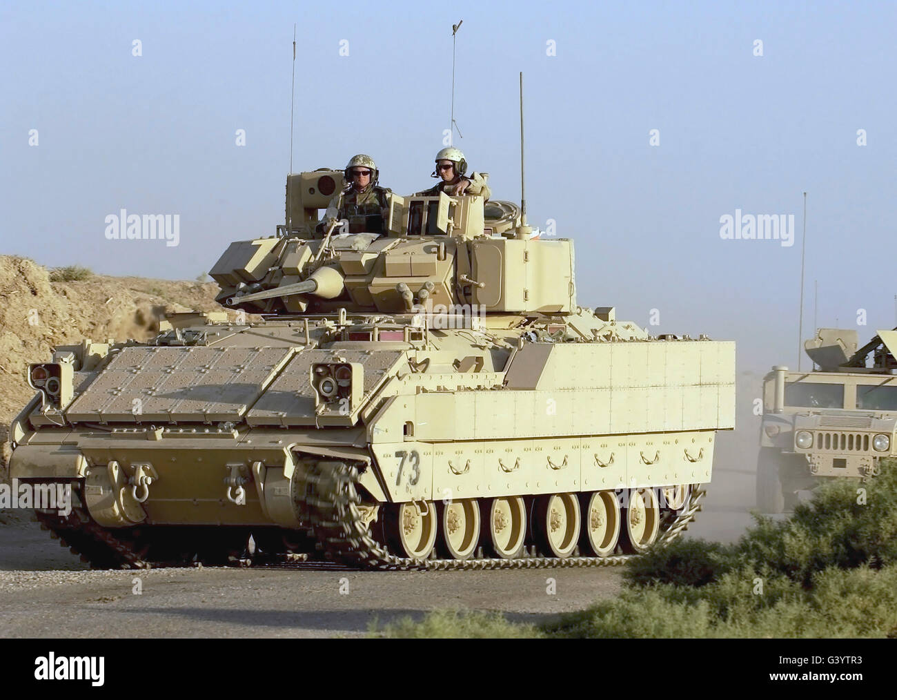 A convoy of Bradley and Humvee armored vehicles. Stock Photo