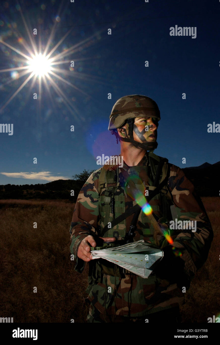 Airman checks map coordinates prior to a tactics exercise. Stock Photo