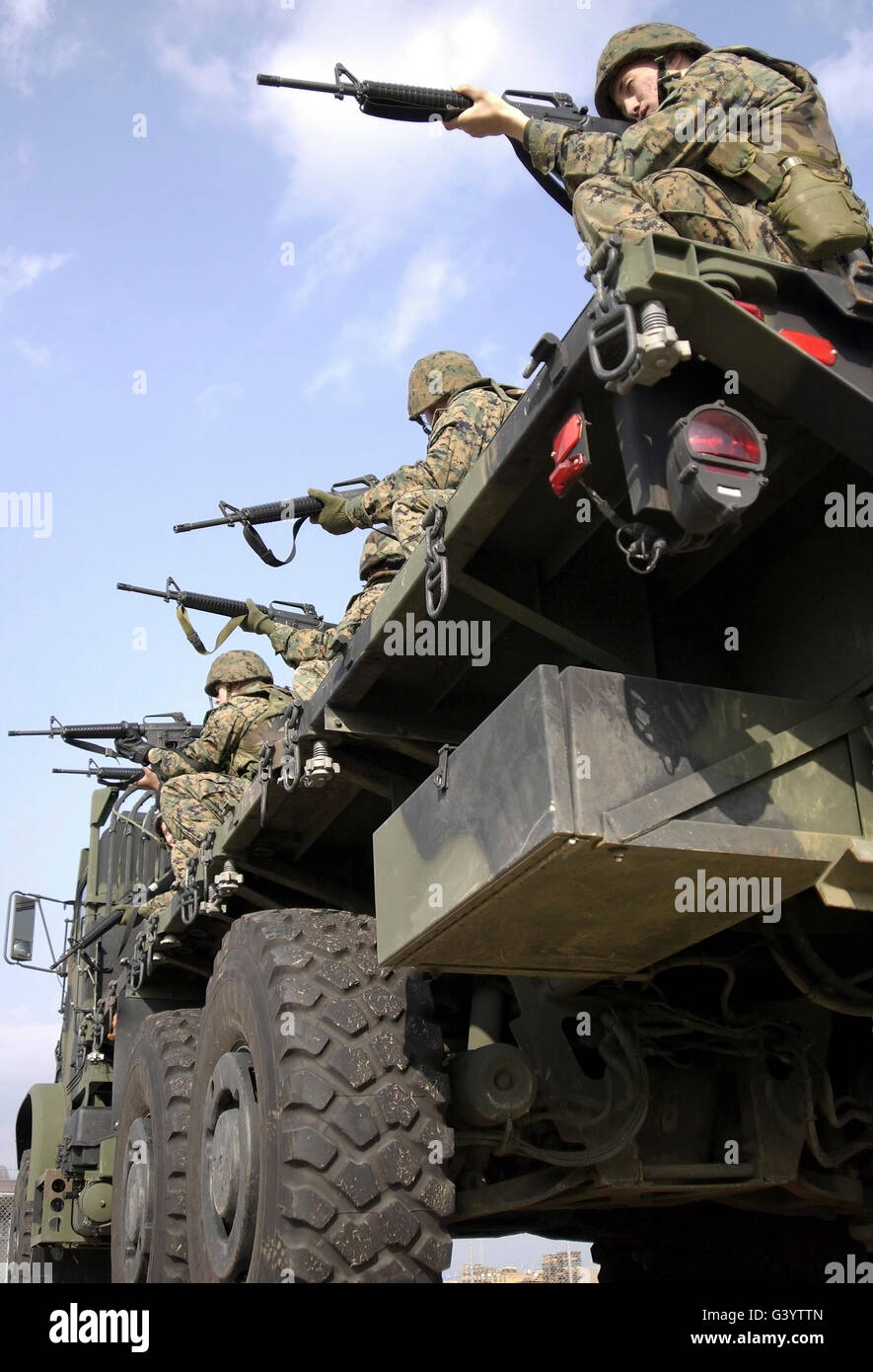 Marines sight in their rifles before reacting to an ambush. Stock Photo