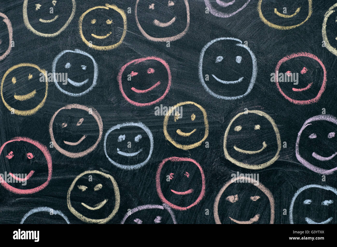Colorful smileys on chalkboard background. Close up. Stock Photo
