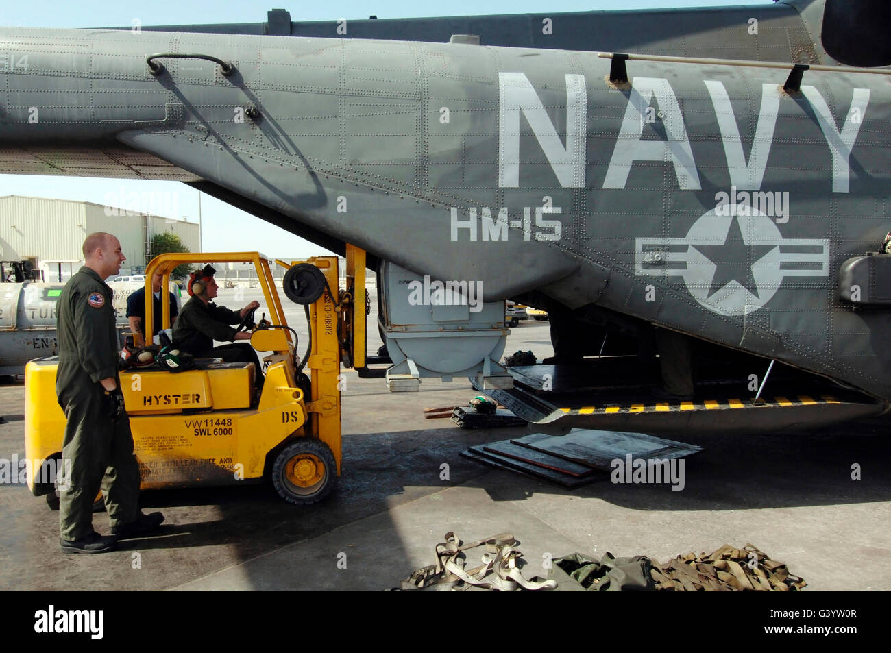 Personnel load cargo onto a MH-53E Sea Dragon helicopter. Stock Photo