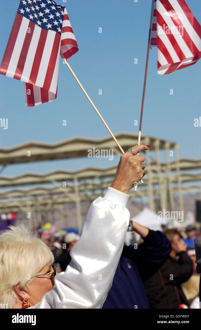 An air show spectator waves her flags. Stock Photo