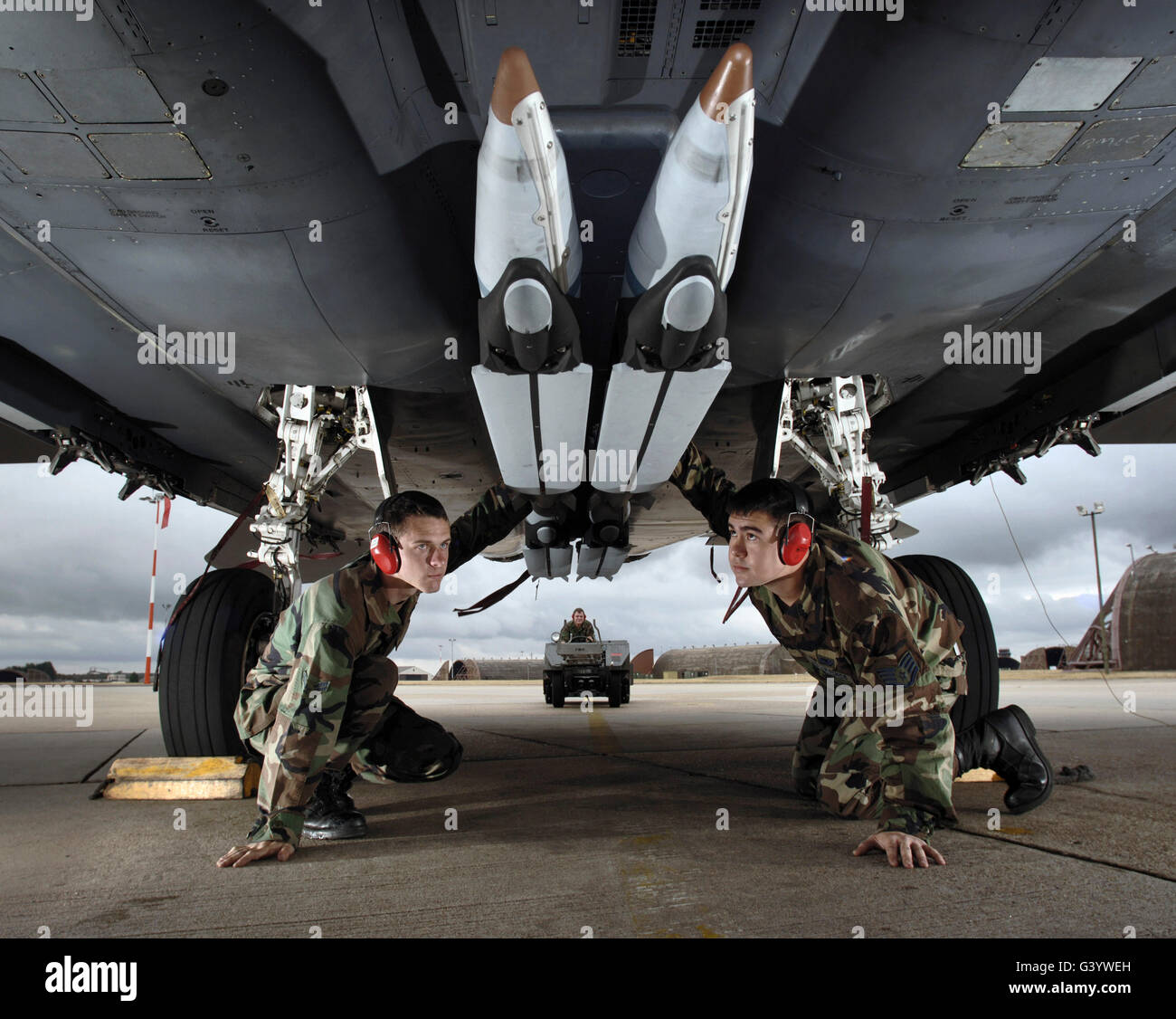 Airmen check the GBU-39 small diameter bombs loaded on an F-15E Strike Eagle. Stock Photo