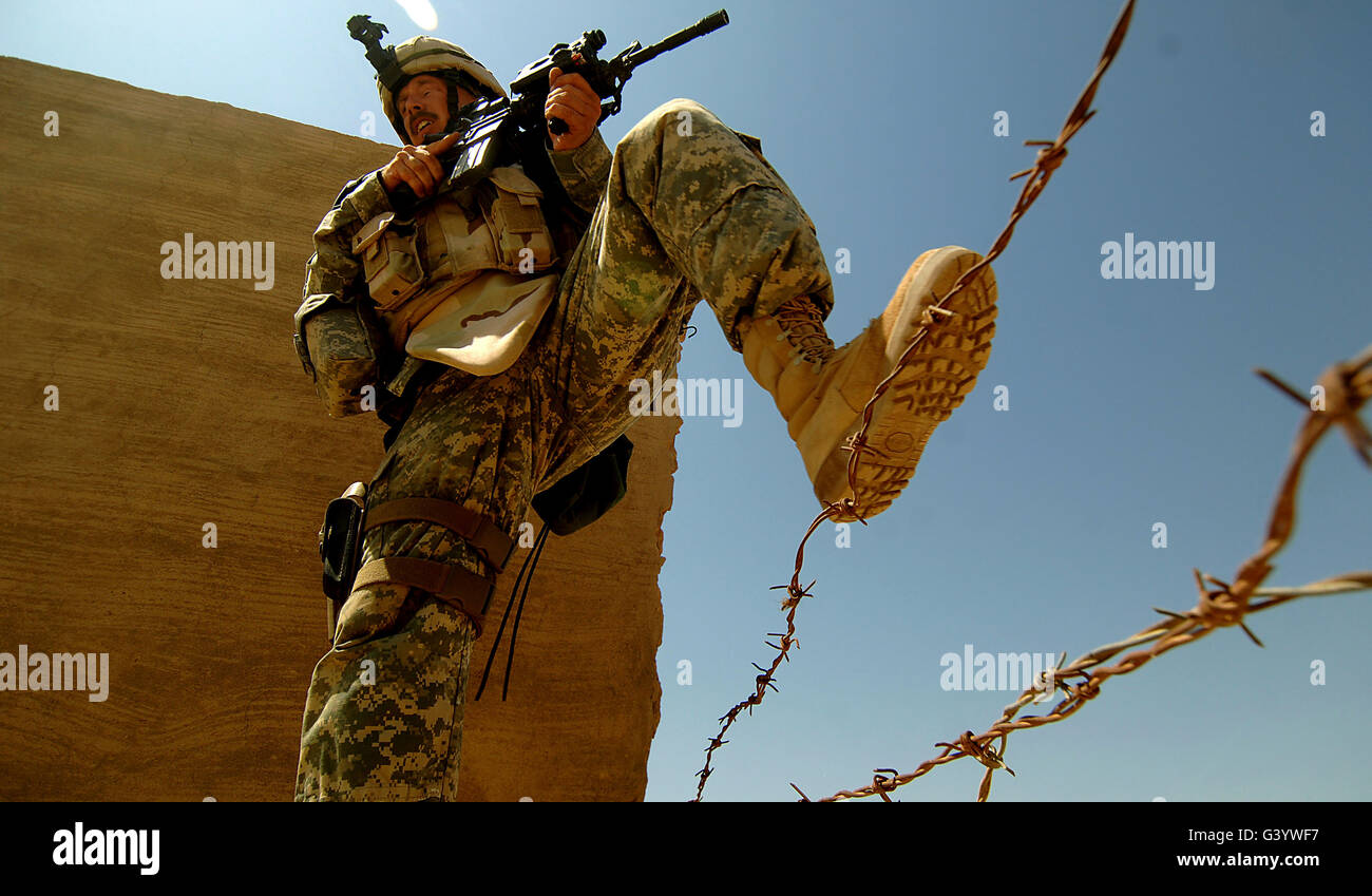 A U.S. Army Soldier searches for insurgents. Stock Photo