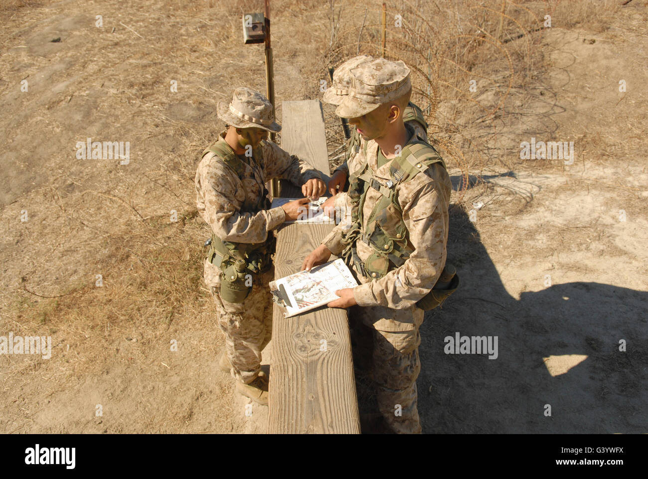 A fire team takes a minute to determine the direction of its next navigation objective. Stock Photo