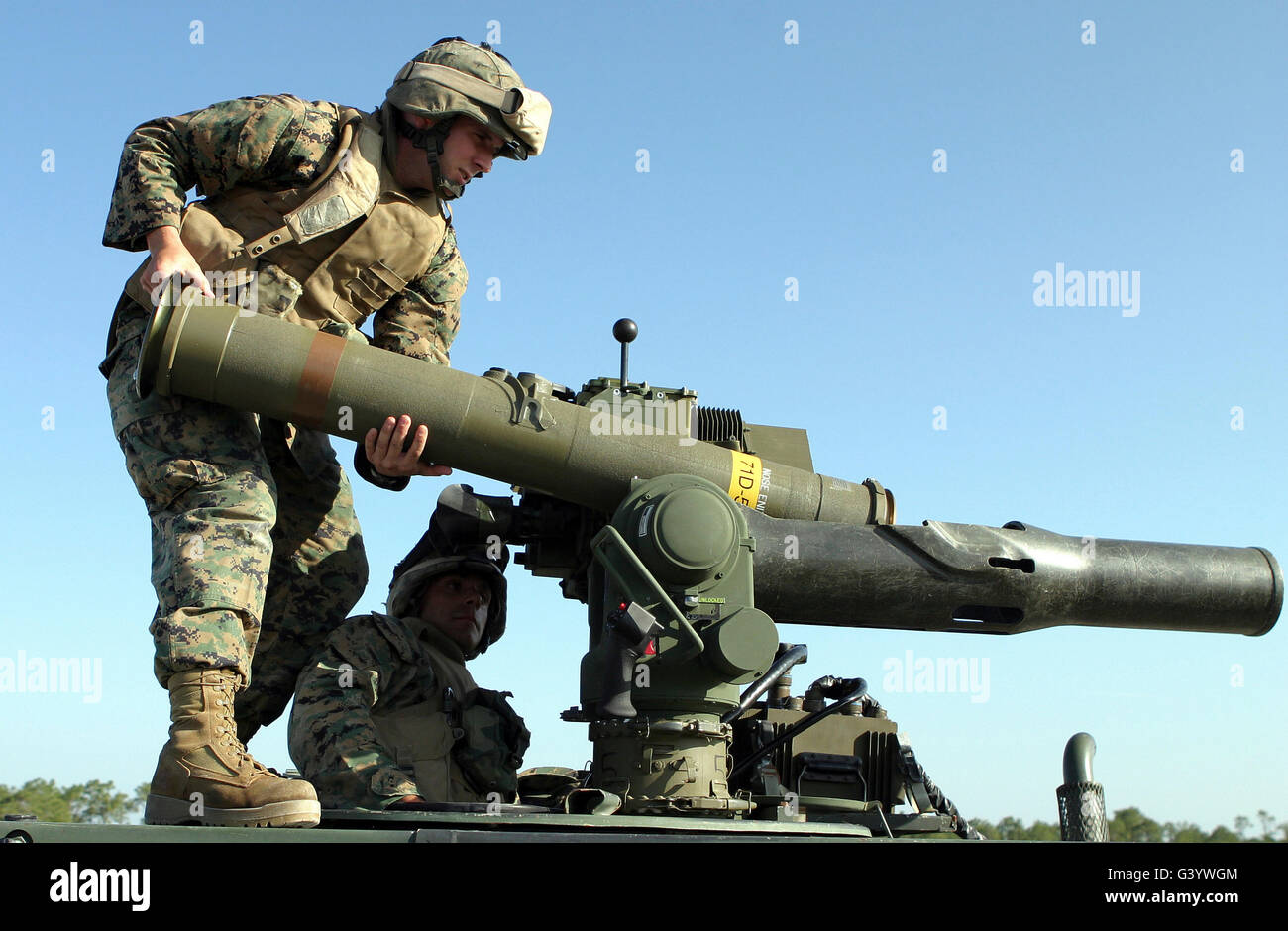 A marine loads a missile into a tube-launched, wire command-link guided missile system. Stock Photo