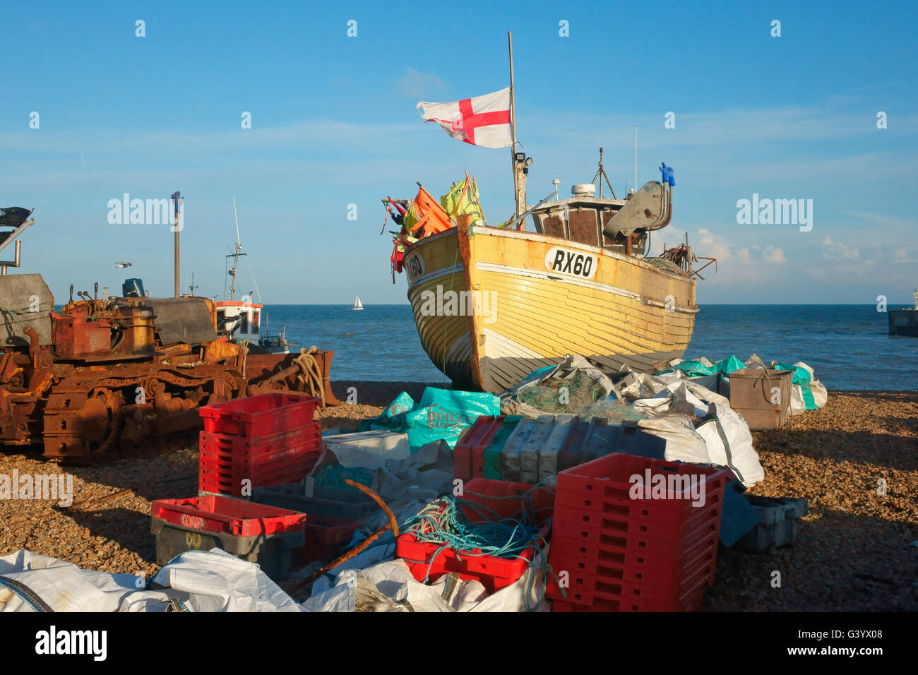 Hastings fishing boat flying the English flag of St George, on the Fisherman's Stade Beach, East Sussex England Great Britain UK Stock Photo
