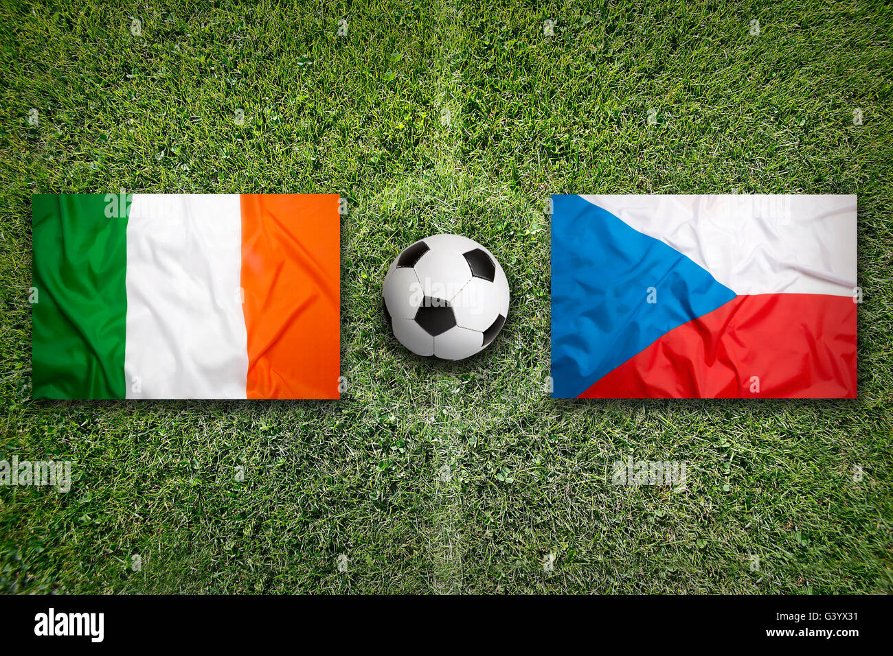 Ireland vs. Turkey flags on green soccer field Stock Photo