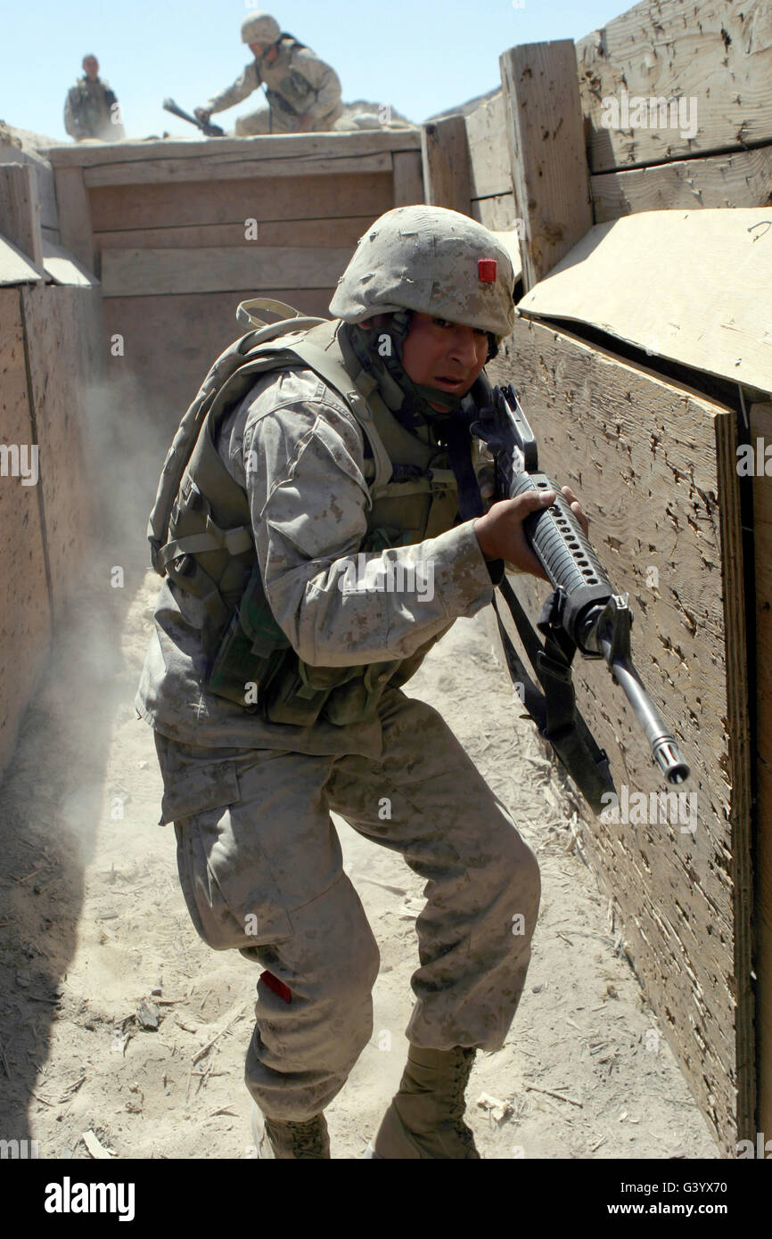 A marine establishes a foothold in a trench during a live-fire exercise. Stock Photo