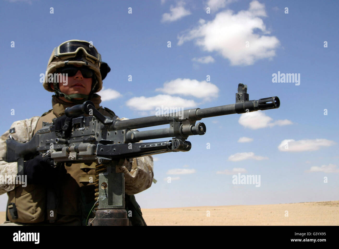 Machine gunner provides security for fellow Marines. Stock Photo