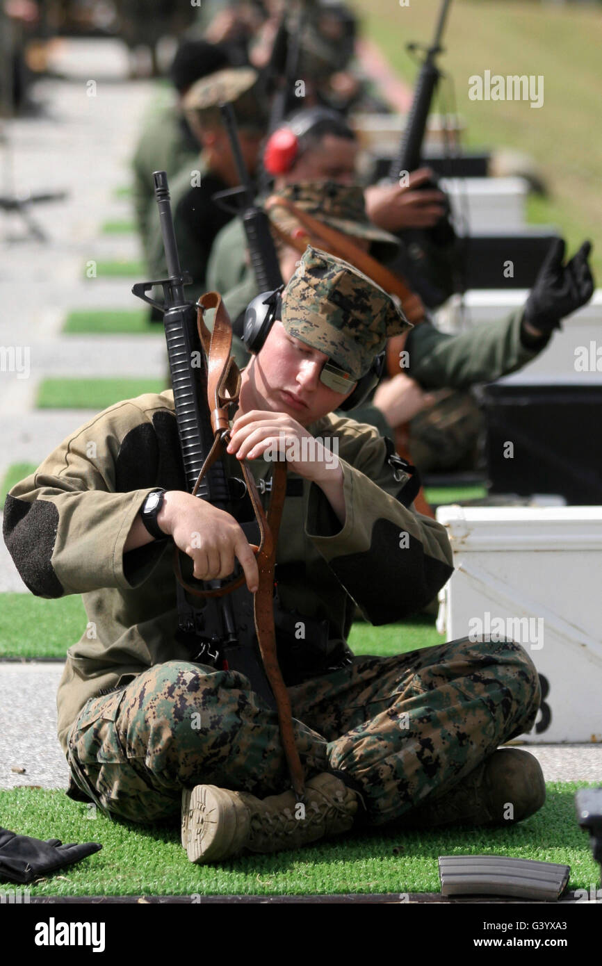A marine makes final adjustments to his M-16A2 service rifle. Stock Photo