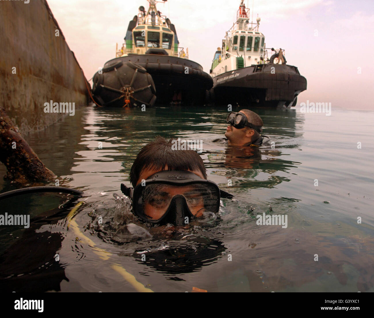 Navy divers inspect a pier at the Port of Djibouti City. Stock Photo