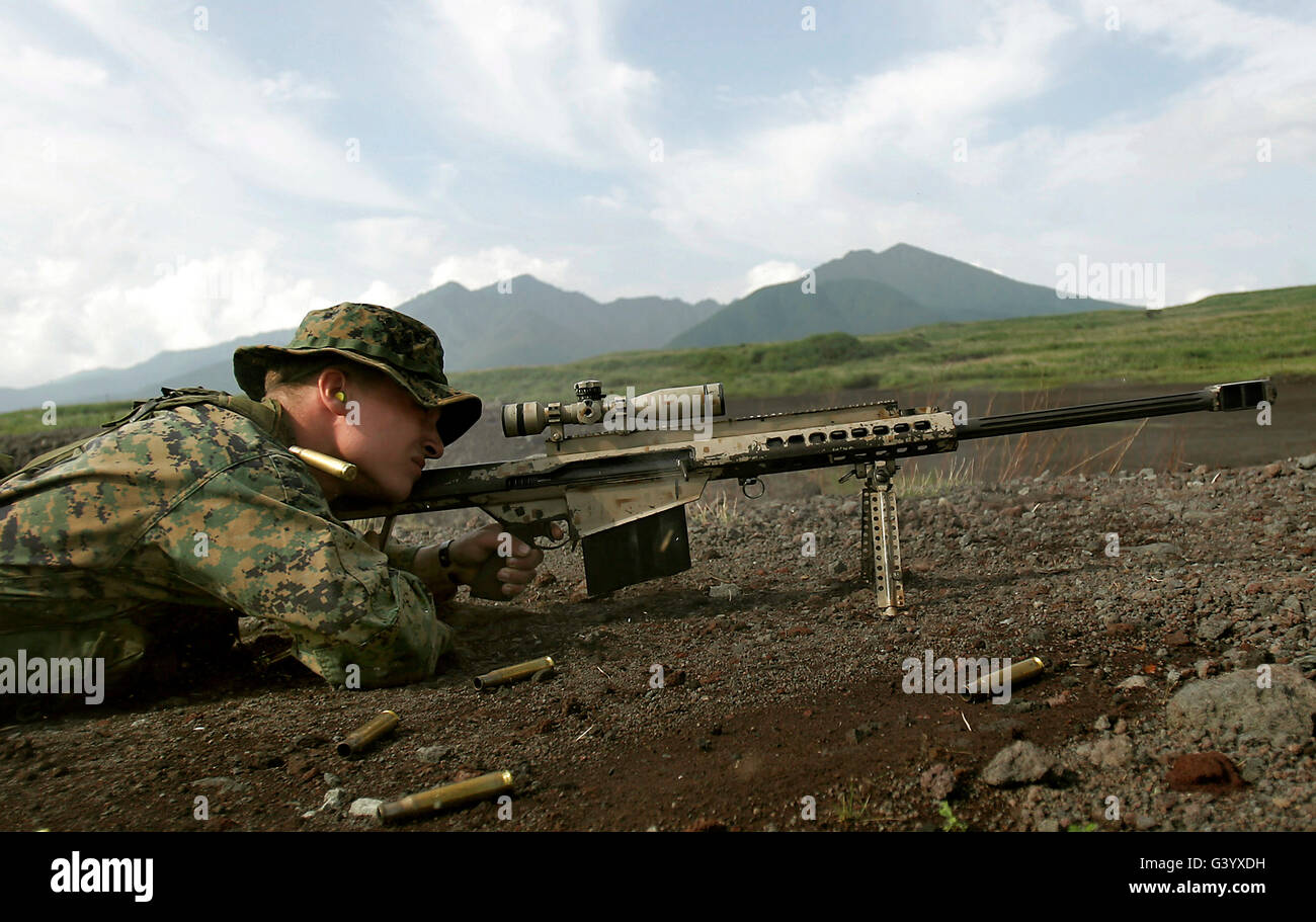 A sniper fires a M82A3 .50-caliber special application scoped rifle. Stock Photo