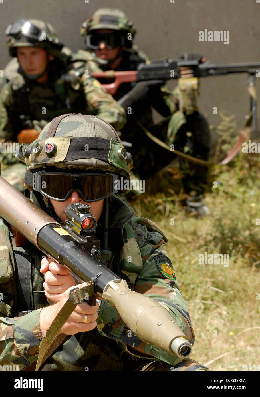A Bulgarian army soldier, scans the battlefield in front of him with his rocket-propelled grenade launcher. Stock Photo