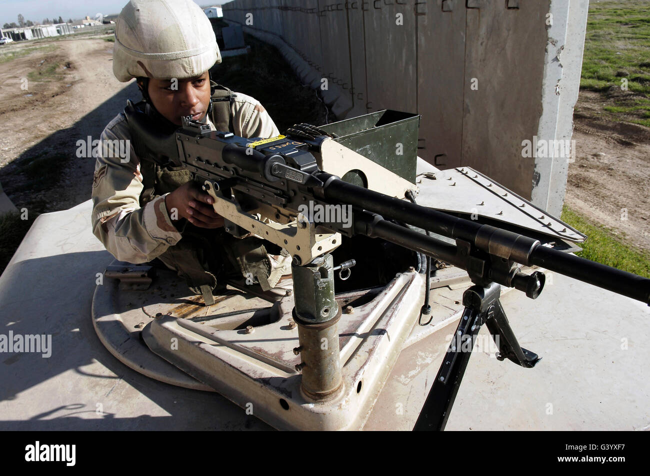 U.S. Air Force Airman aims a M240B machine gun. Stock Photo