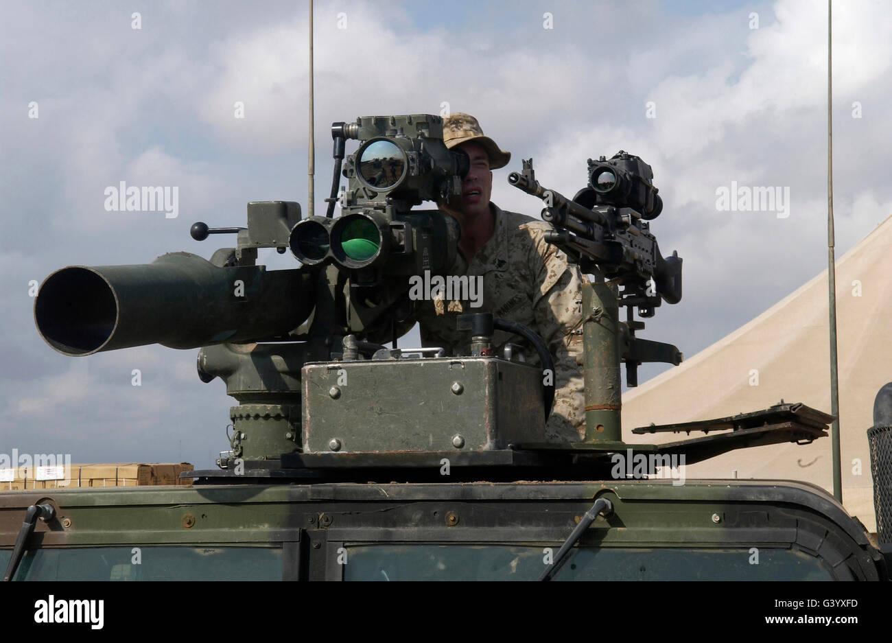 U.S Marine looks through a sight on a Tow Missile mounted on top of a humvee. Stock Photo