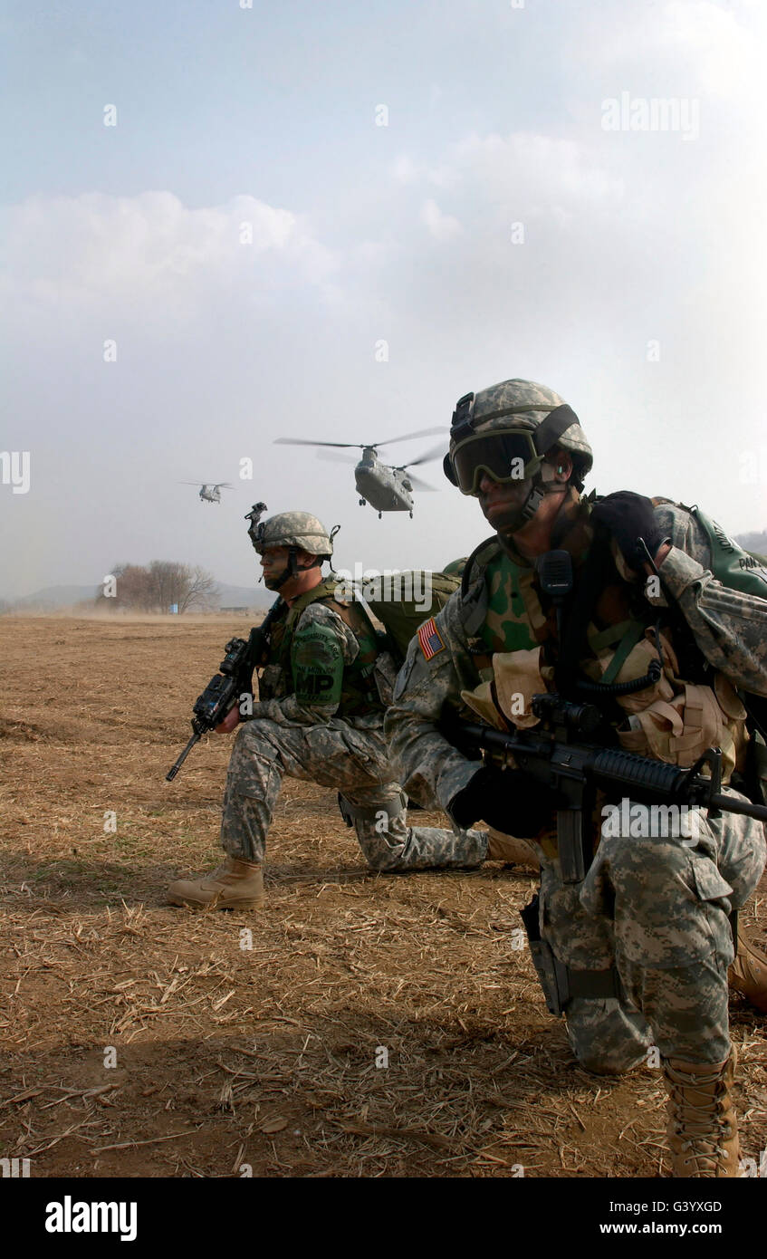 U.S. Army Sergeants secure a helicopter landing zone for a CH-47 Chinook. Stock Photo