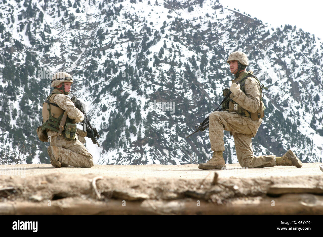 Riflemen provide security on a rooftop. Stock Photo