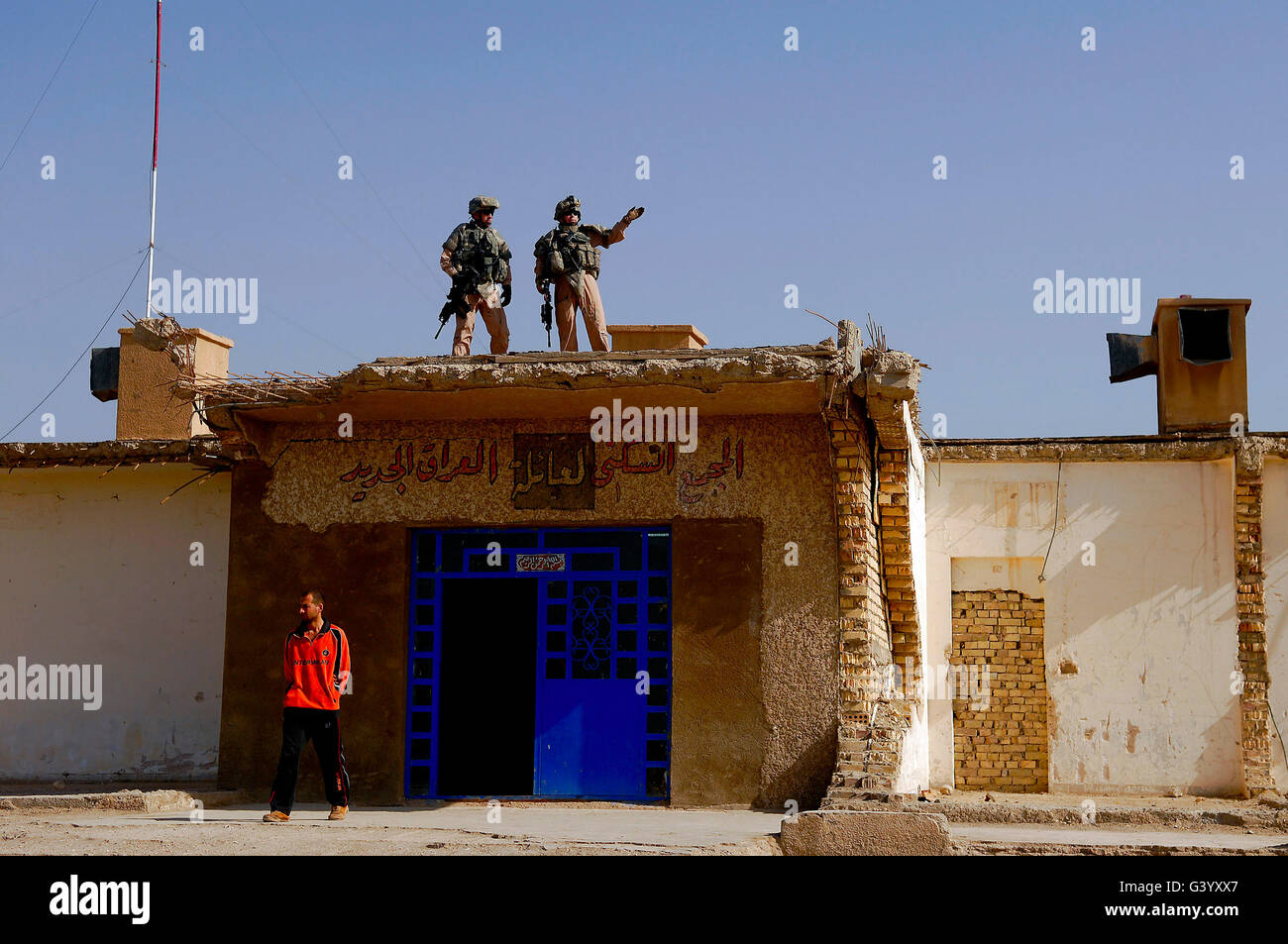 Soldiers discuss the new Iraqi police station. Stock Photo