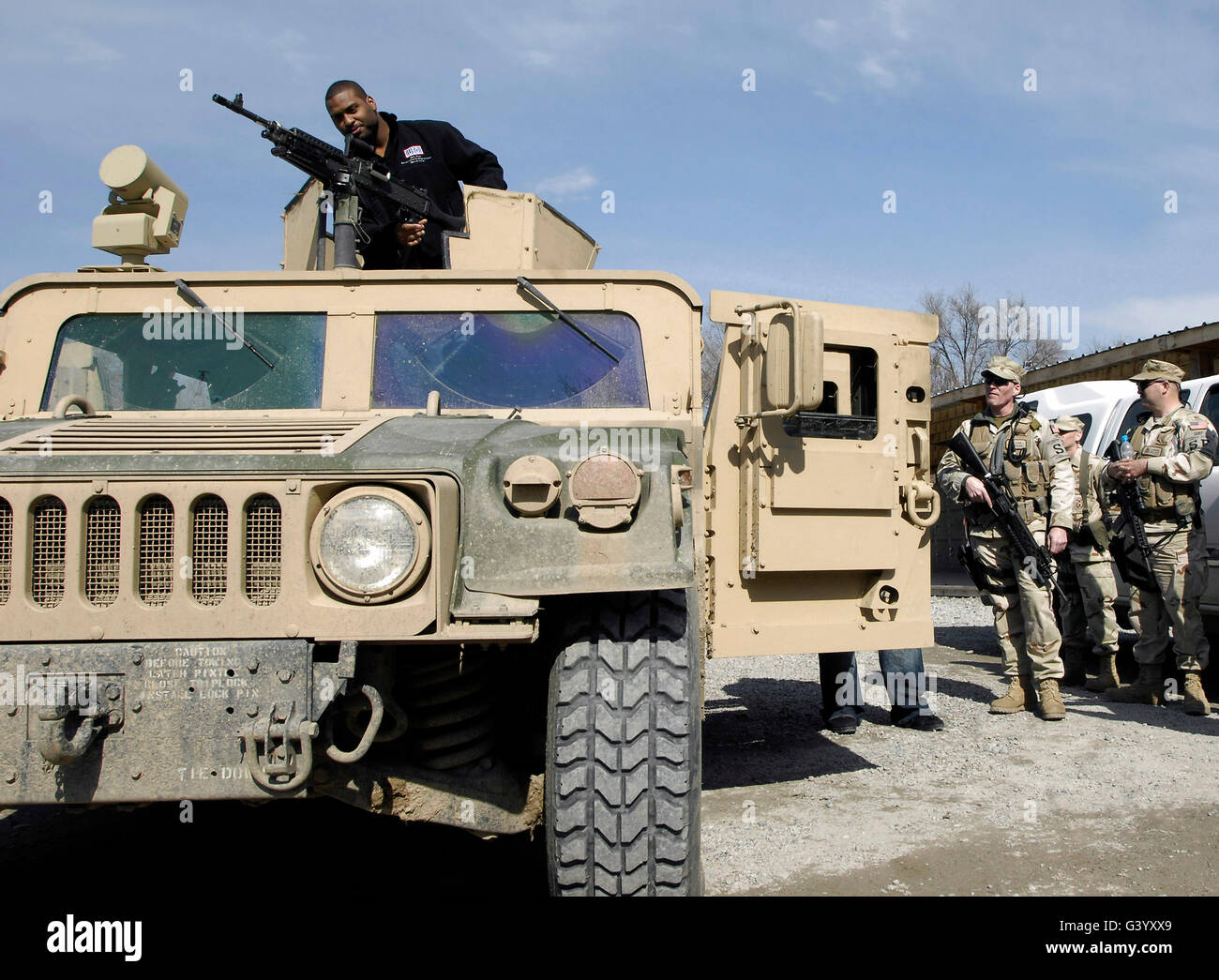 Pro football athlete checks out a M240B machine gun on a Humvee Stock