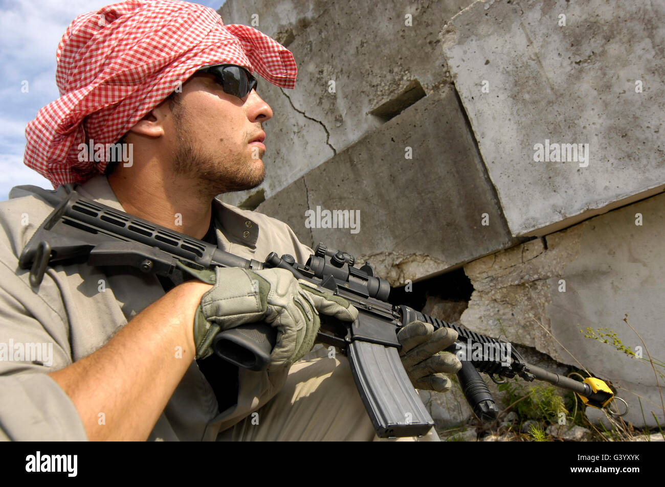 A member of Opposing Forces engaged in simulated combat. Stock Photo