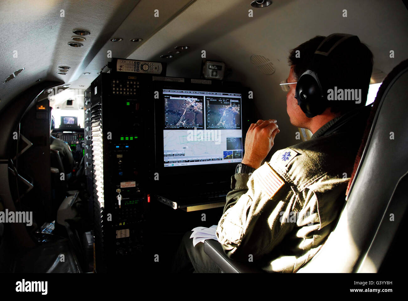 System operator operates a console aboard an RC-26 aircraft. Stock Photo