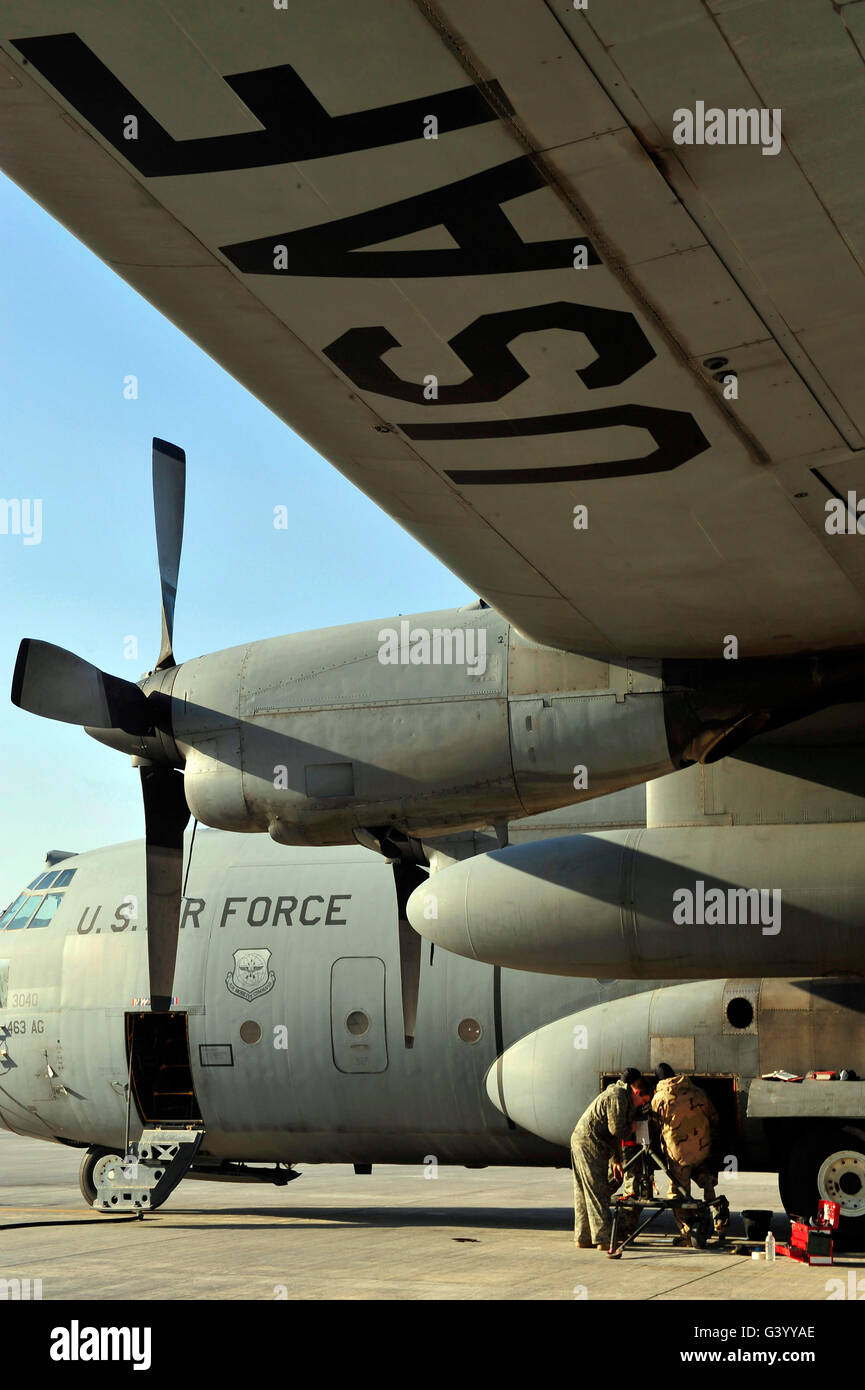 Mechanics change an auxiliary power unit of a C-130 Hercules. - Stock Image
