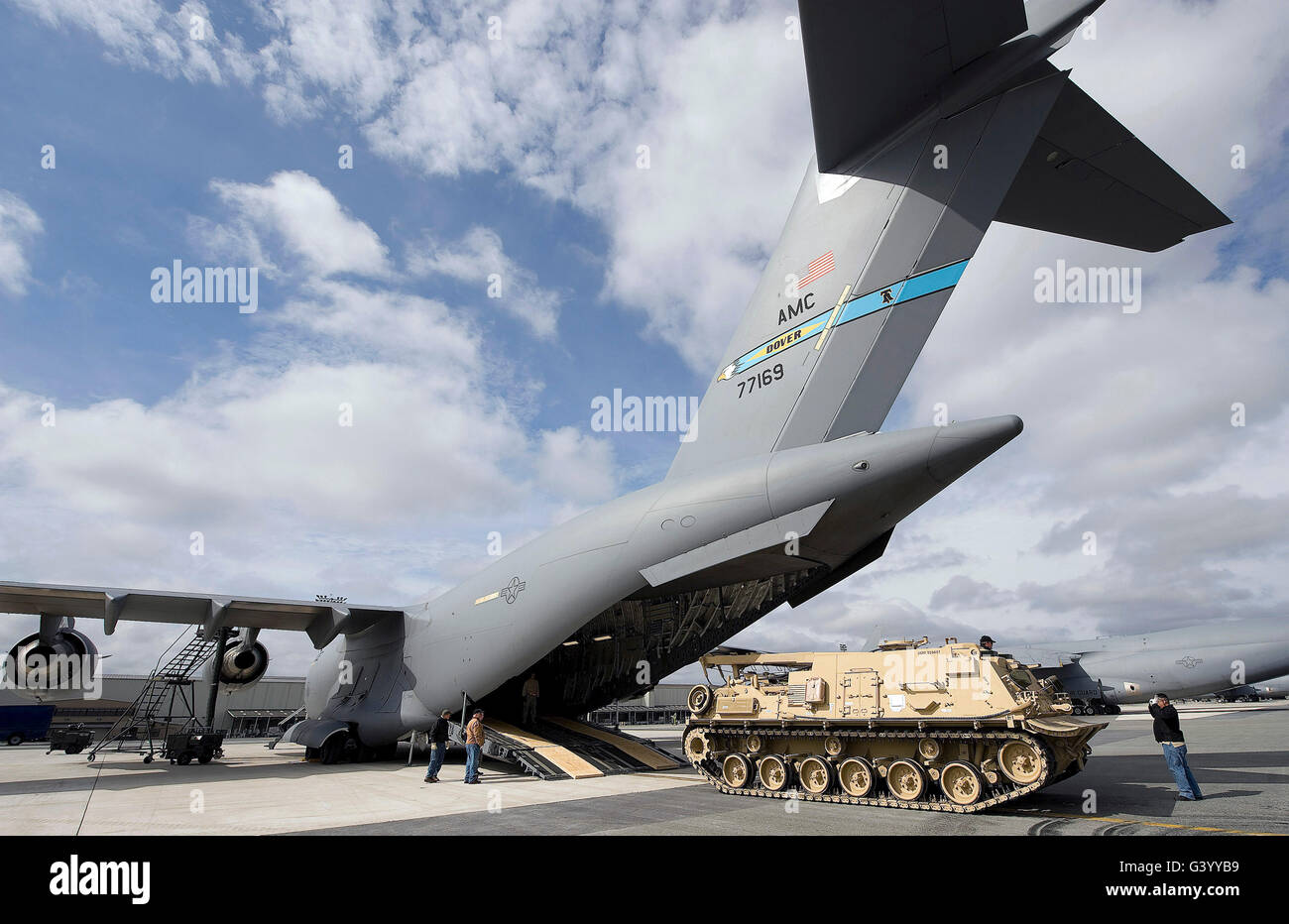 Workers direct a U.S. Army M88A2 HERCULES onto a C-17 Globemaster III. Stock Photo