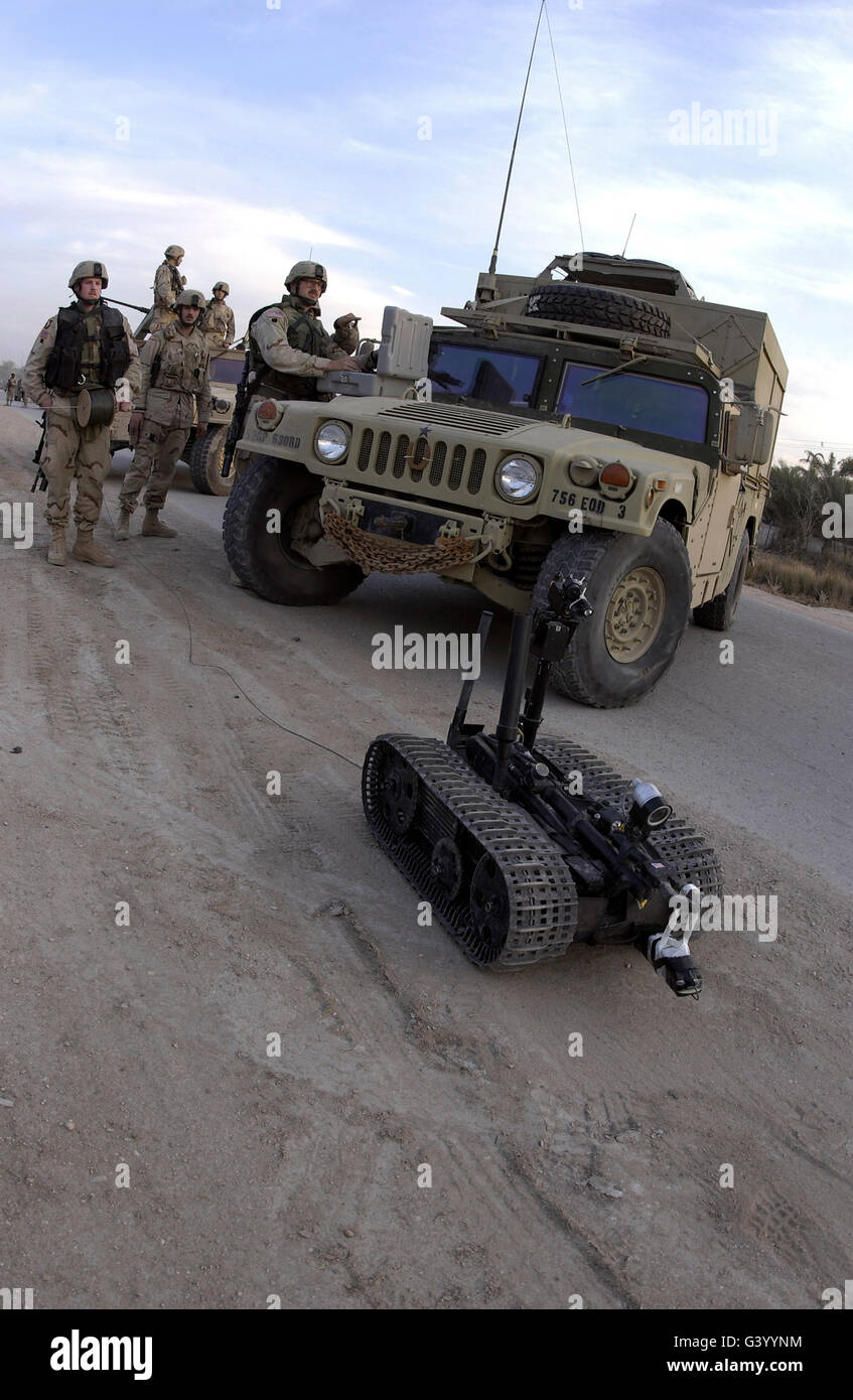 A U.S. soldier deploys a remotely controlled explosive ordinance disposal robot. Stock Photo