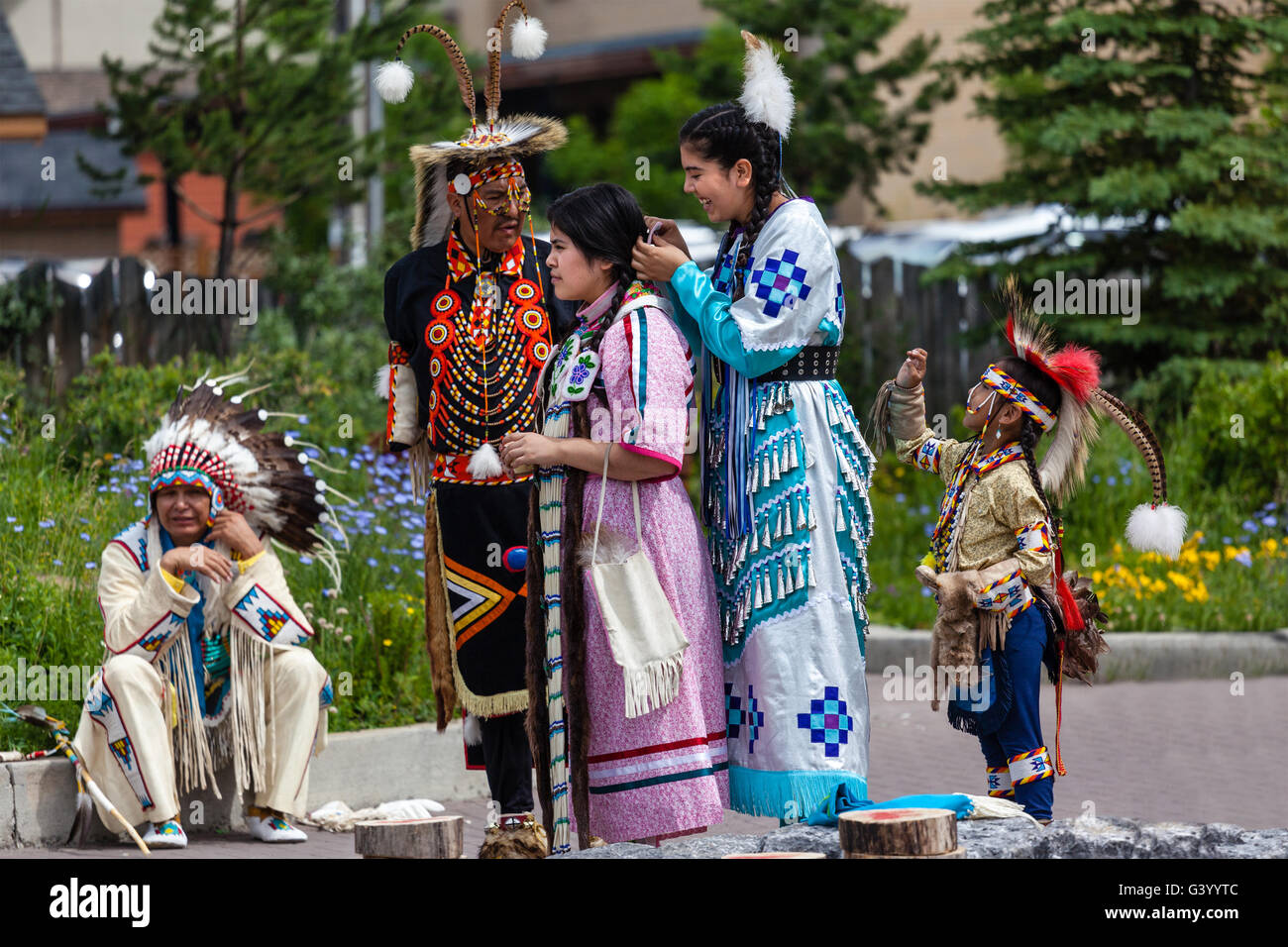 BANFF, CANADA - JUL 3: Young native Blackfoot Indian dancers put the finishing touches on their costumes for a performance. Stock Photo