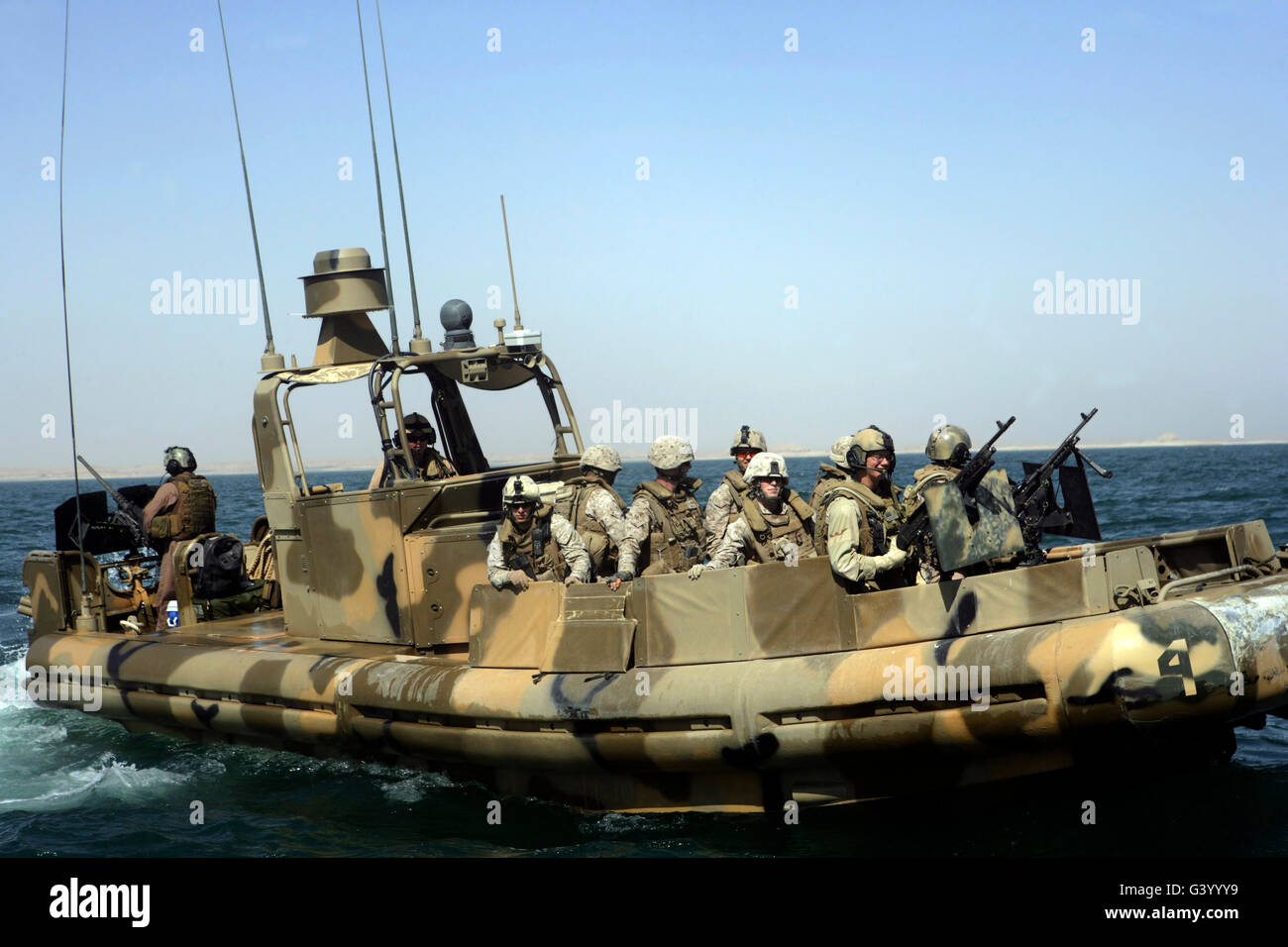 Sailors assigned to Riverine Squadron 3 taking Marines on a tour of Lake Quadsiyah near Haditha, Iraq. Stock Photo