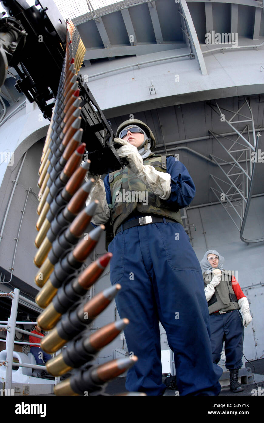 Gunner's Mate Seaman taking aim on a .50-caliber machine gun at a floating target aboard USS Ronald Reagan. Stock Photo